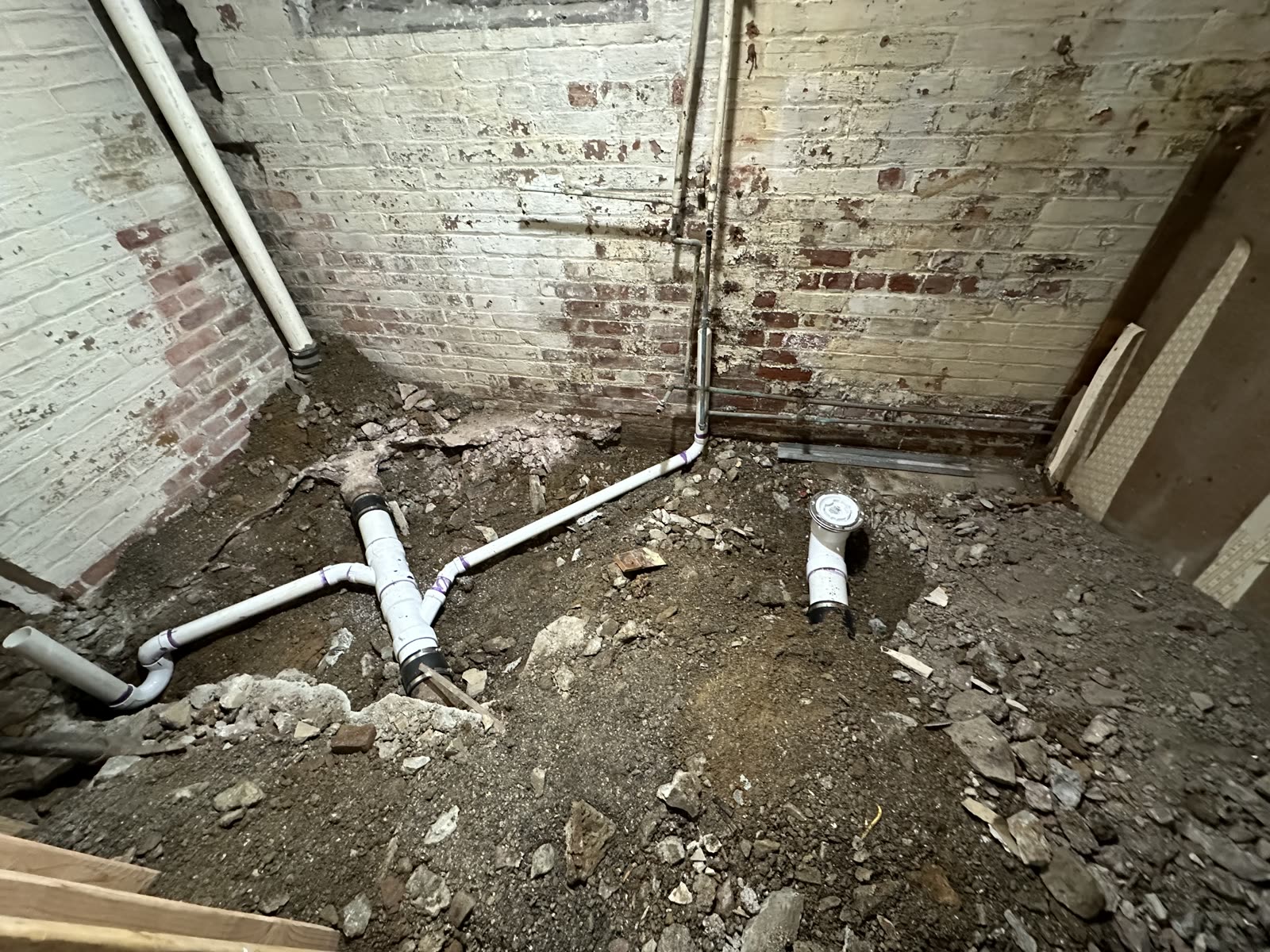 New below-floor drain and water lines installed during an ARCED renovation
