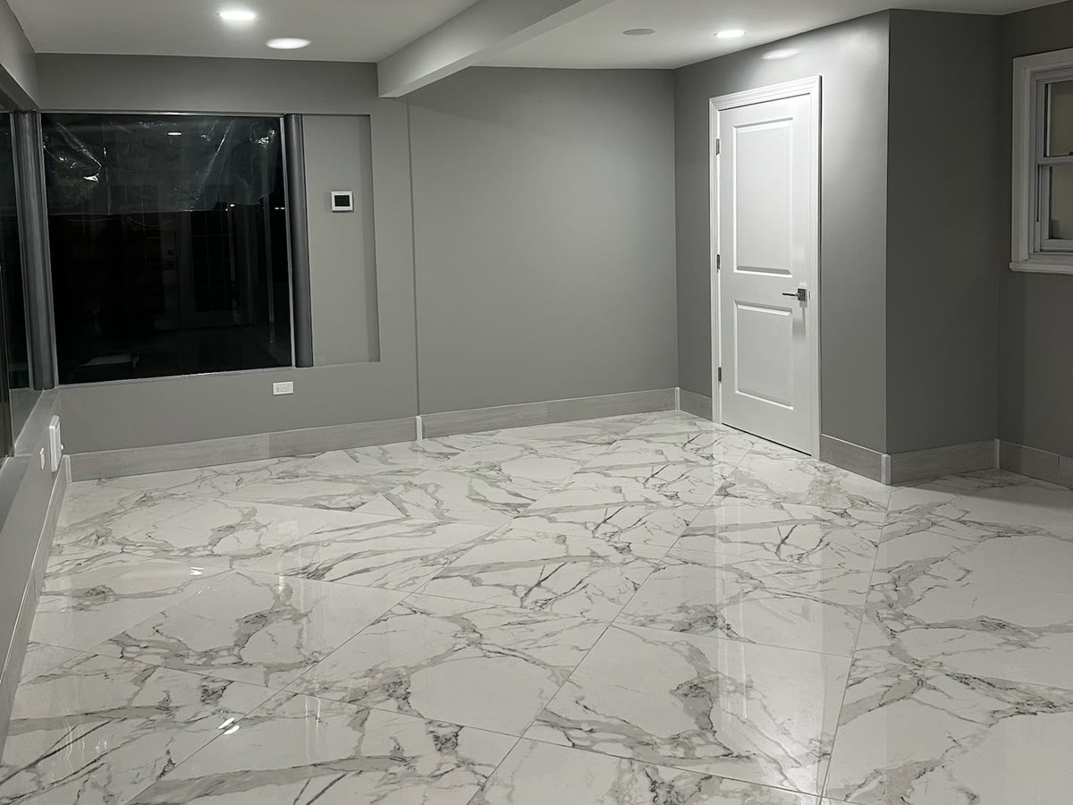 Finished Northern New Jersey basement by ARCED with bright living space and marble-look tile